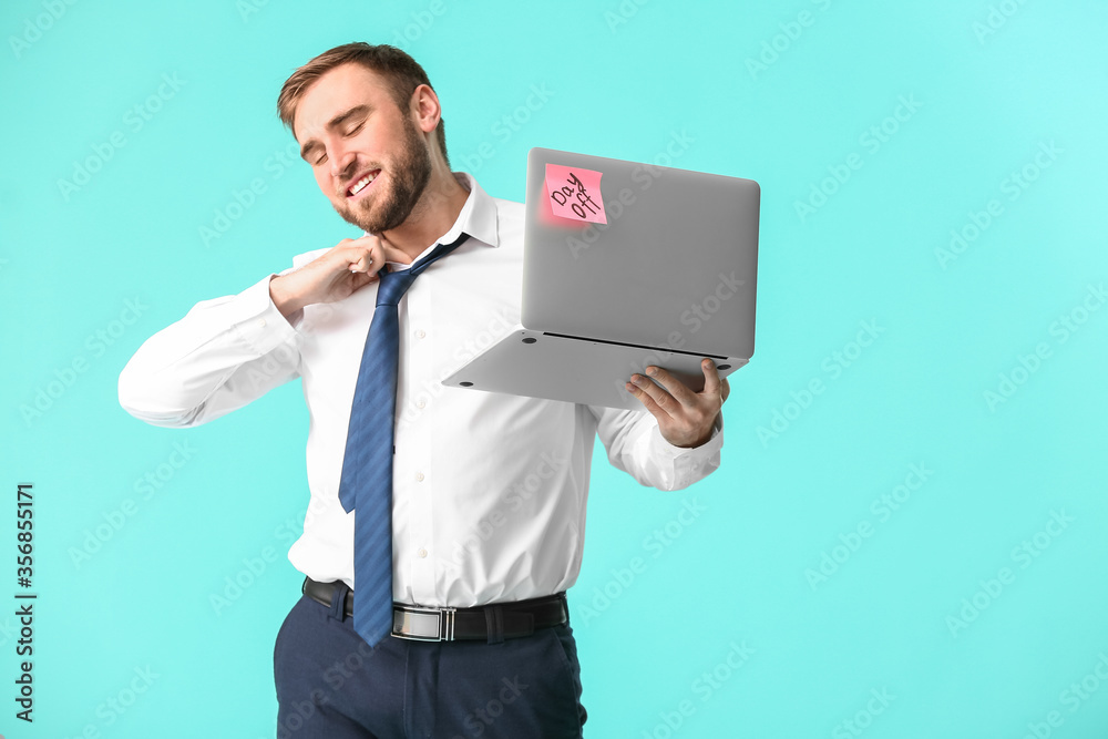Young businessman with laptop on color background. Day off concept