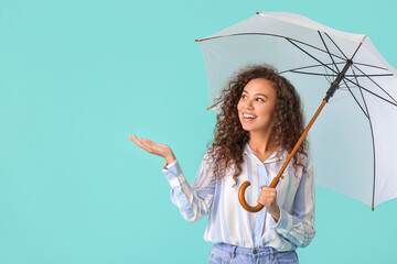 Canvas Print - Beautiful young woman with umbrella on color background