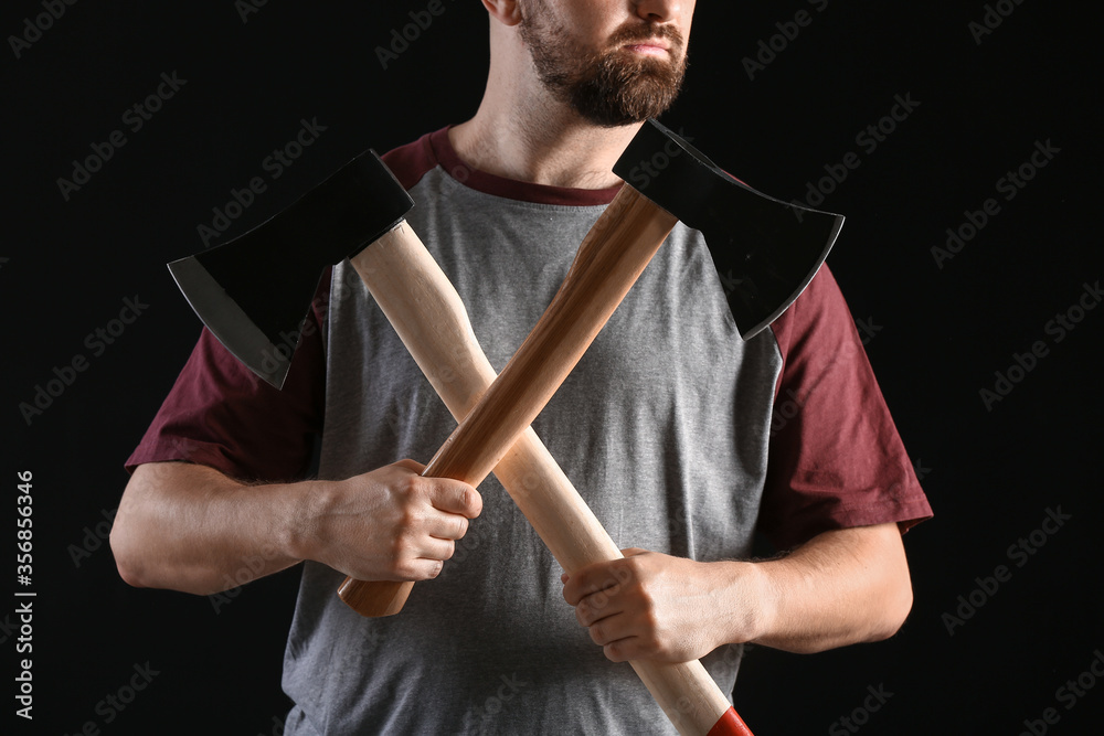 Handsome lumberjack on dark background