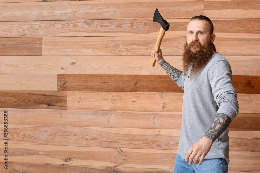 Handsome lumberjack on wooden background