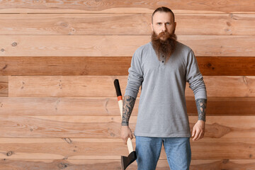 Poster - Handsome lumberjack on wooden background