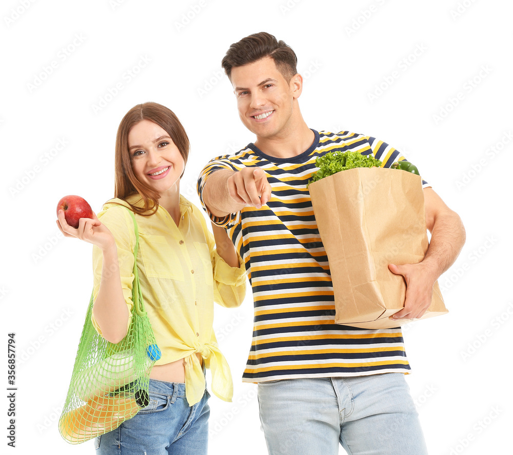 Couple with food in bags on white background