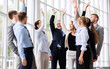 © Syda Productions - corporate and teamwork concept - happy business team making high five or celebrating success at office