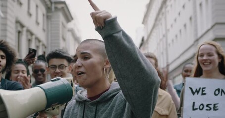 Wall Mural - Student with a megaphone shouting slogans during a protest against their civil rights. Young protesters protesting on the street.
