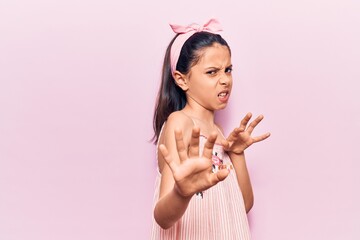 Sticker - Beautiful child girl wearing casual clothes disgusted expression, displeased and fearful doing disgust face because aversion reaction. with hands raised