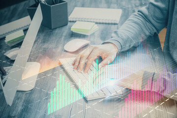 Double exposure of financial graph with man works in office on background. Concept of analysis.