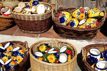 Wall Mural - Ceramic pots for sale in wicker baskets outside a village shop, Frigiliana, Andalusia, Spain.