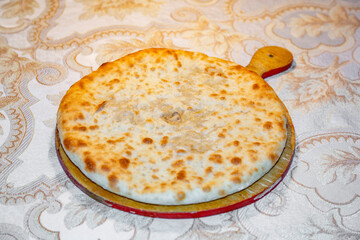 Freshly cooked delicious closed pie with hot cheese inside