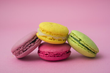 Wall Mural - Closeup of french traditional macarons on pink background