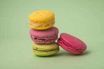 Wall Mural - Closeup of french traditional macarons on green background