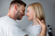 © LIGHTFIELD STUDIOS - side view of cheerful couple smiling while looking at each other