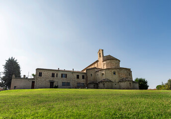 Wall Mural - Italy, Carolingian church,view of the apse externally, green lawn in the foreground, blue sky