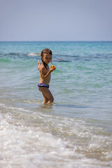 little girl eating a peach