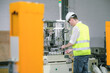 © 2B - Engineer Worker quality control, maintenance, holding laptop Factory Warehouse Locations plant operators and engineers.