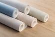 © Nana_studio - rolls of multi-colored paper wallpaper on a wooden table