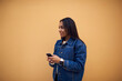 © BullRun - Afro american female in trendy jeans jacket standing on promotional background gesture while talking