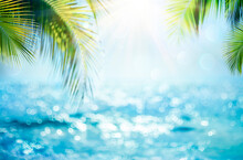 Blurred Blue Sky And Sea With Bokeh Light And Leaves Palm Tree - Summer Vacation Concept
