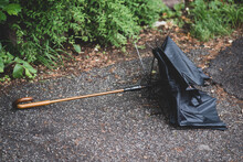 Broken Umbrella Thrown Away And Lying On The Street.