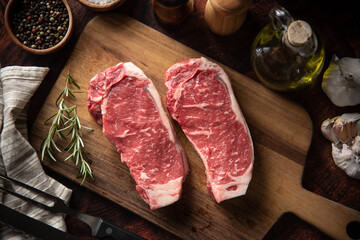 Poster - raw strip beef steak meat on wooden cutting board