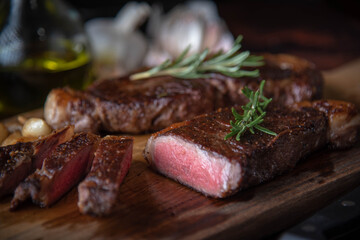 Wall Mural - dark image of sirloin beef steak on wooden board