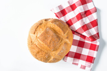 Hand made bread on red and white napkin and white background. top view, copy space