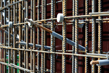 SELANGOR, MALAYSIA -SEPTEMBER 19, 2015: Hot rolled deformed steel bars or steel reinforcement bar and the concrete spacer. The spacer used to created gap between the reinforcement bar and the formwork