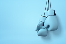 3d Close-up Rendering Of Pair Of Light Blue Boxing Gloves Hanging On String On Light Pink Background With Copy Space.