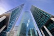 © ST-art - Office and residential skyscrapers on bright sun and clear blue sky background. Commercial real estate investment. Modern business city district. Office buildings. Financial city area. Downtown.
