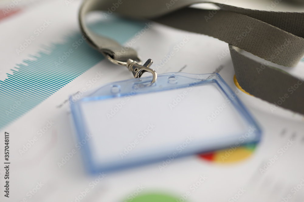 Close-up of empty paper in name tag. Document with colourful diagram ...