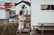 © Maskot - Rear view of family walking by cabin
