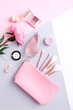 Beauty background with facial cosmetic products and peony on colorful pastel background. Top view, flat lay.