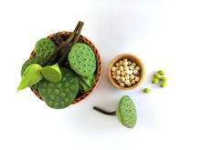 The Calyxes Of The Lotus Are Lotus Bud And Young Pod Included In The Basket. And White Lotus Seeds In A Wooden Cup The Seeds Are Not Peeled On The Side. Isolated On White Background.