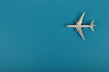 toy air plane on blue background top view with copy space