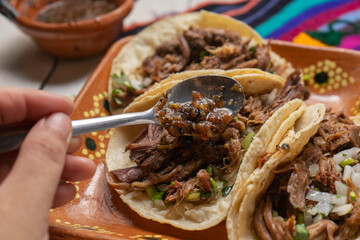 Mexican slow cooked lamb tacos also called barbacoa on white background