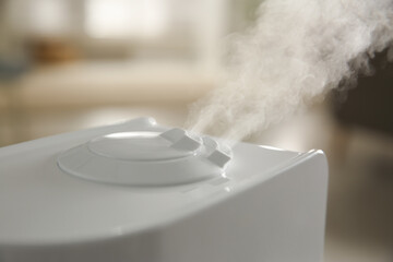 Canvas Print - Modern humidifier on blurred background, closeup view