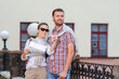 © danmorgan12 - Vacations And Traveling Ideas. Positive Caucasian Couple Traveling Around City With Camera. Looking for Destination with City Map.