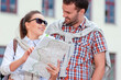 © danmorgan12 - Vacations Ideas. Positive Caucasian Couple Traveling Around City With Camera. Looking for Destination with City Map.