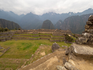 Machu Picchu courtyard, stone walls, terraces and andes mountains on the background