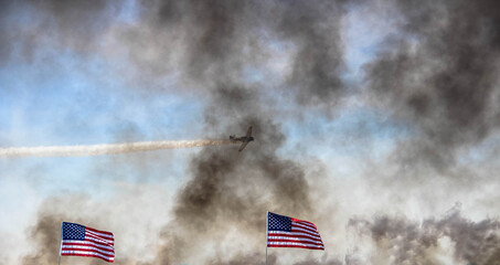 Reenactment fire of what the war aircraft can do, with the USA's flags.