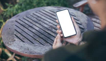 cell phone mockup image blank white screen.woman hand holding texting using mobile on desk at coffee shop.background empty space for advertise.work people contact marketing business,technology