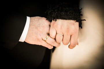 Canvas Print - Closeup shot of wedding couple holding hands