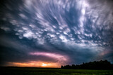 Fototapeta Tęcza - Late evening mammatus clouds with lightning