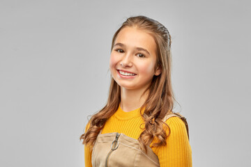 Sticker - people concept - portrait of smiling teenage girl over grey background