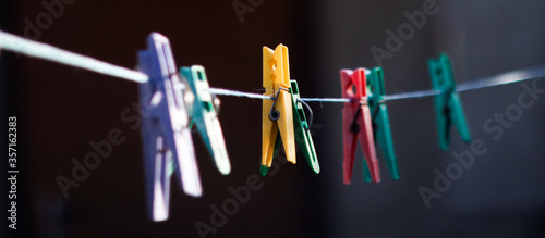 Cuadros en Lienzo colorful clothespins hanging on a clothesline