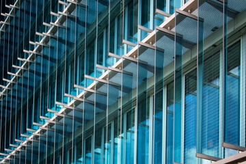 Close up view of facade of a modern architecture with blue glass panels in Berlin