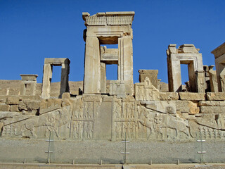 Wall Mural - Richly decorated stairs leading to palace of Xerxes. Reliefs are depicting royal servants and courtiers, and Lion and Bull, ancient symbols of Nowruz, and other ornament. Persepolis, near Shiraz, Iran