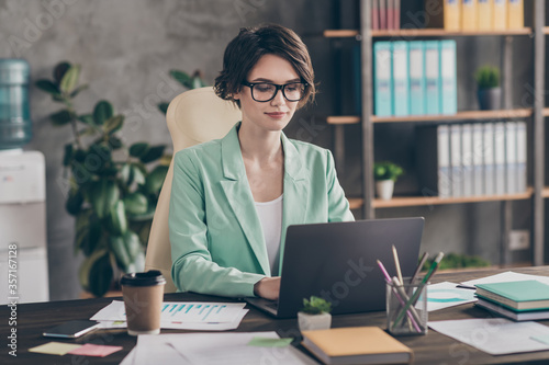 Fotografía Focused girl agent lawyer manager sit desk chair work laptop have online communi