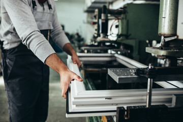 PVC industry worker making PVC frames for windows and doors