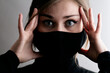 © fantom_rd - portrait of young beautiful woman in protective black stylish mask with hand on head, lifestyle 2020 under quarantine and epidemic, fashion disease, emotional shock