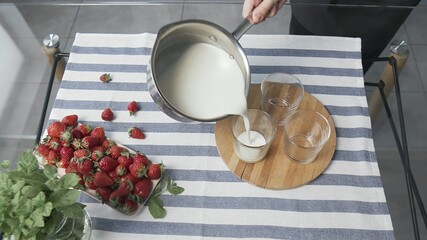 Woman cooking delicious Italian dessert Panna Cotta.